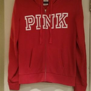 Pink hooded sweatshirt with zipper.